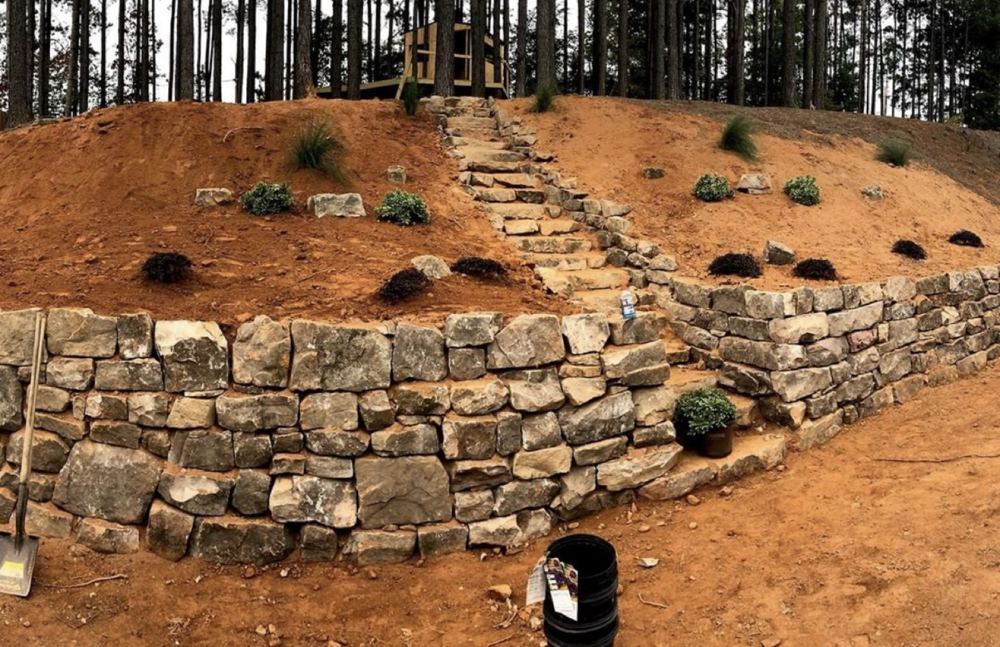 Stacked-stone retaining wall and erosion control on red Georgia clay